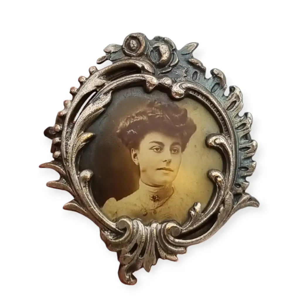 Antique Art Nouveau brooch with female portrait, floral frame, France 1900.