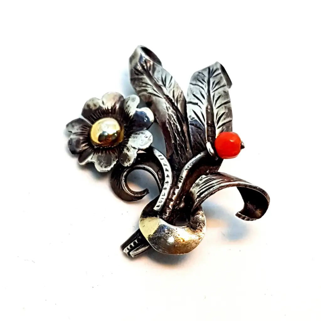 Brooch from the 50s in silver, gold and coral in the shape of a bouquet.