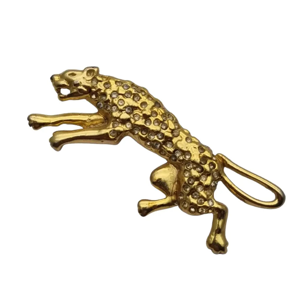 Vintage gold panther brooch with white rhinestones.