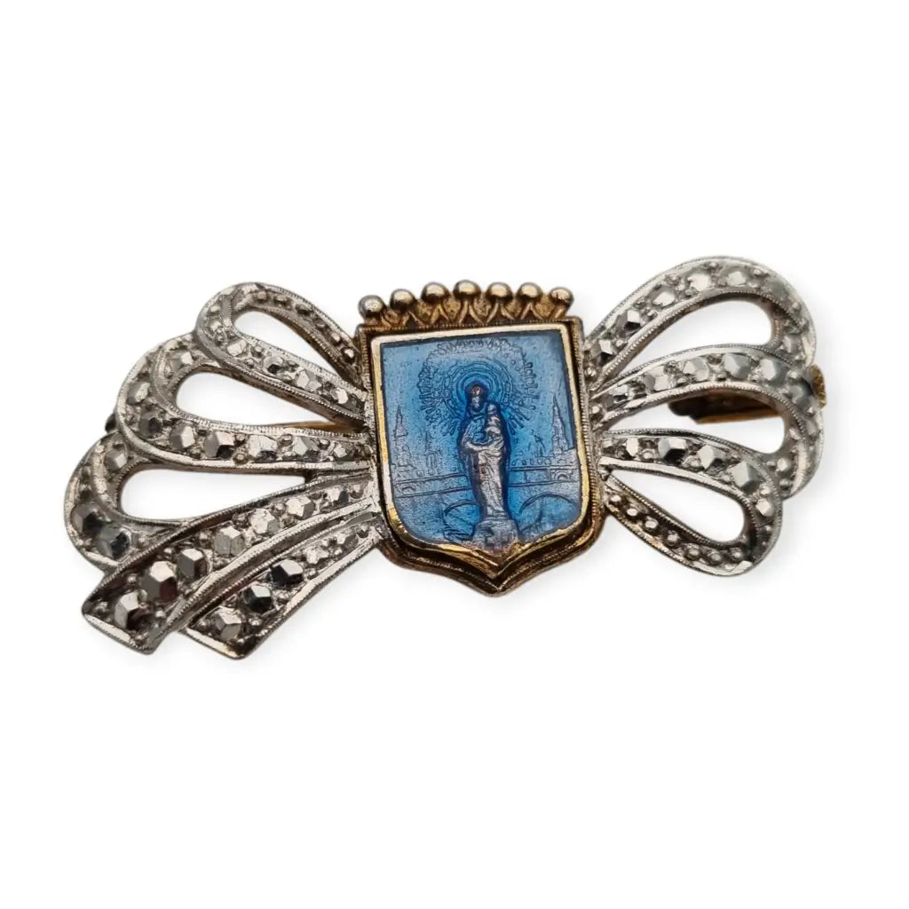 Religious brooch made of 900 silver with blue enamel of the Virgin with a bow and crown.